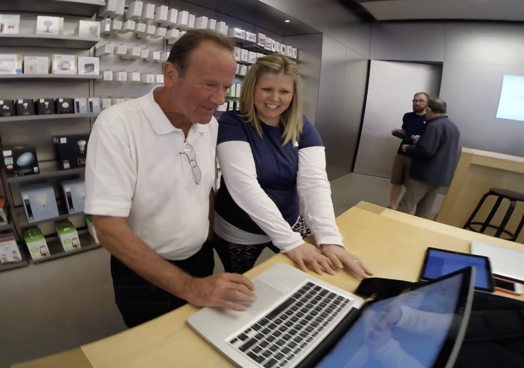 Sooz Young delivering one-to-one Apple training with a customer at the Apple Store. Hands-on Creative role teaching MacBook skills, part of the foundation of her Technology Coaching approach to digital skills.